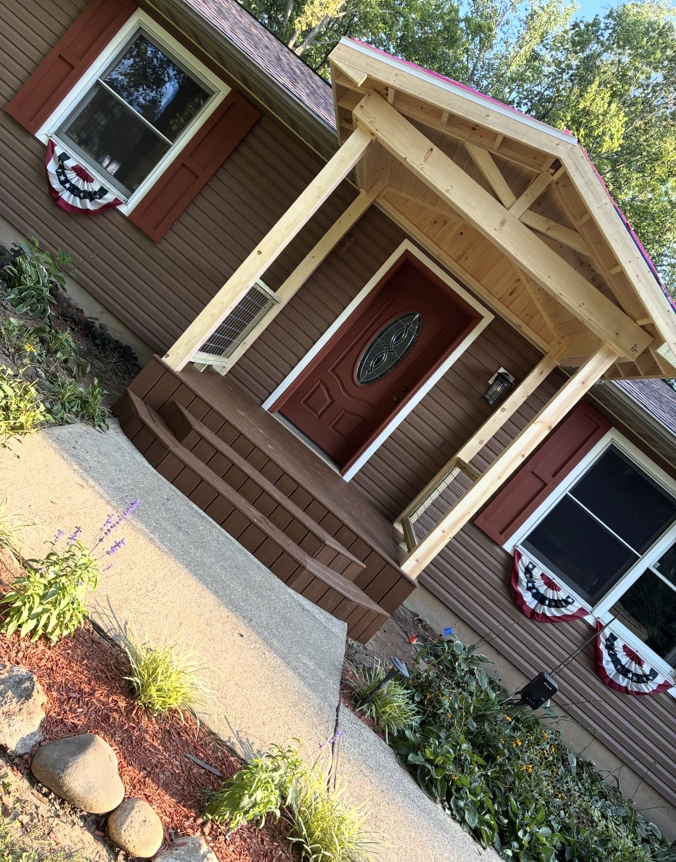 Front entry porch with timber posts and a wood gable